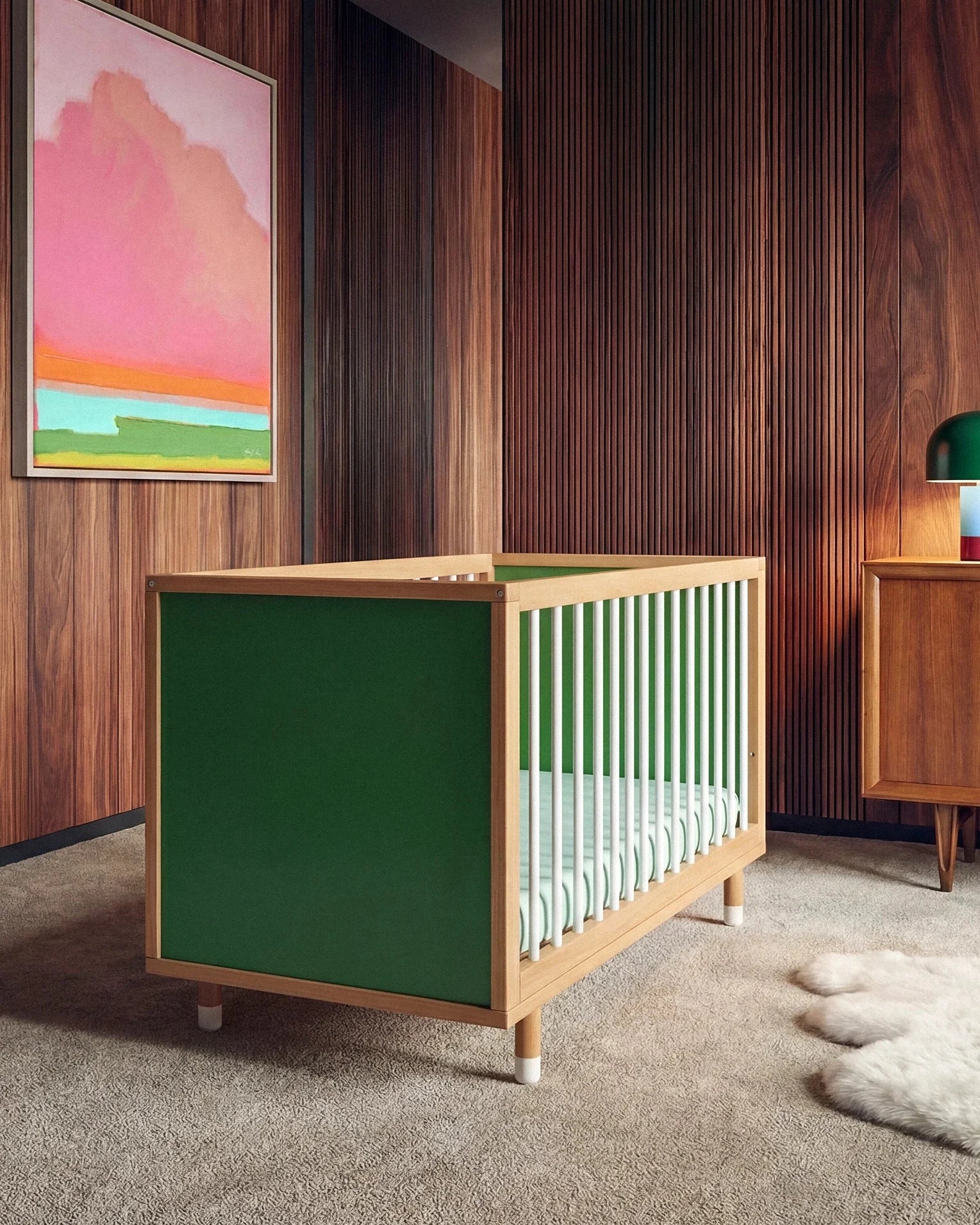 Bold Baby Cot in Green and Mint colourway, front three-quarter view showing the green panel