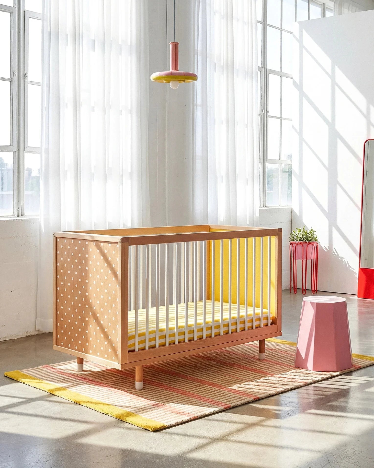 Polkadot and yellow panels of the Bold Baby Cot