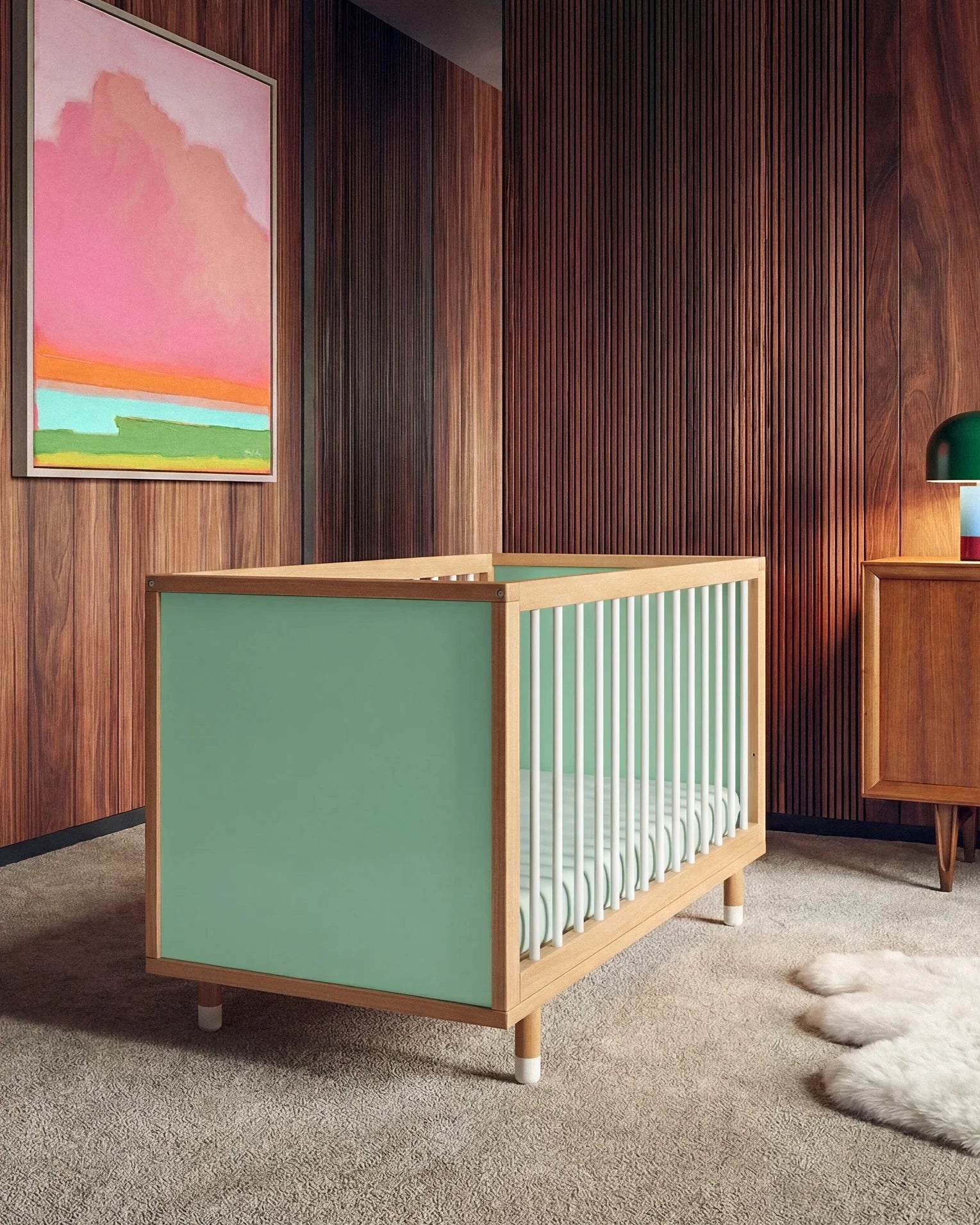 Bold Baby Cot in Green and Mint colourway, front three-quarter view showing the mint panel