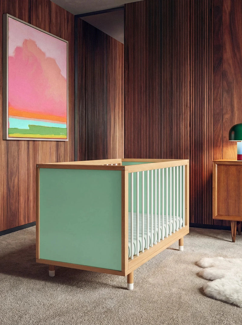 Bold Baby Cot in Green and Mint colourway, front three-quarter view showing the mint panel