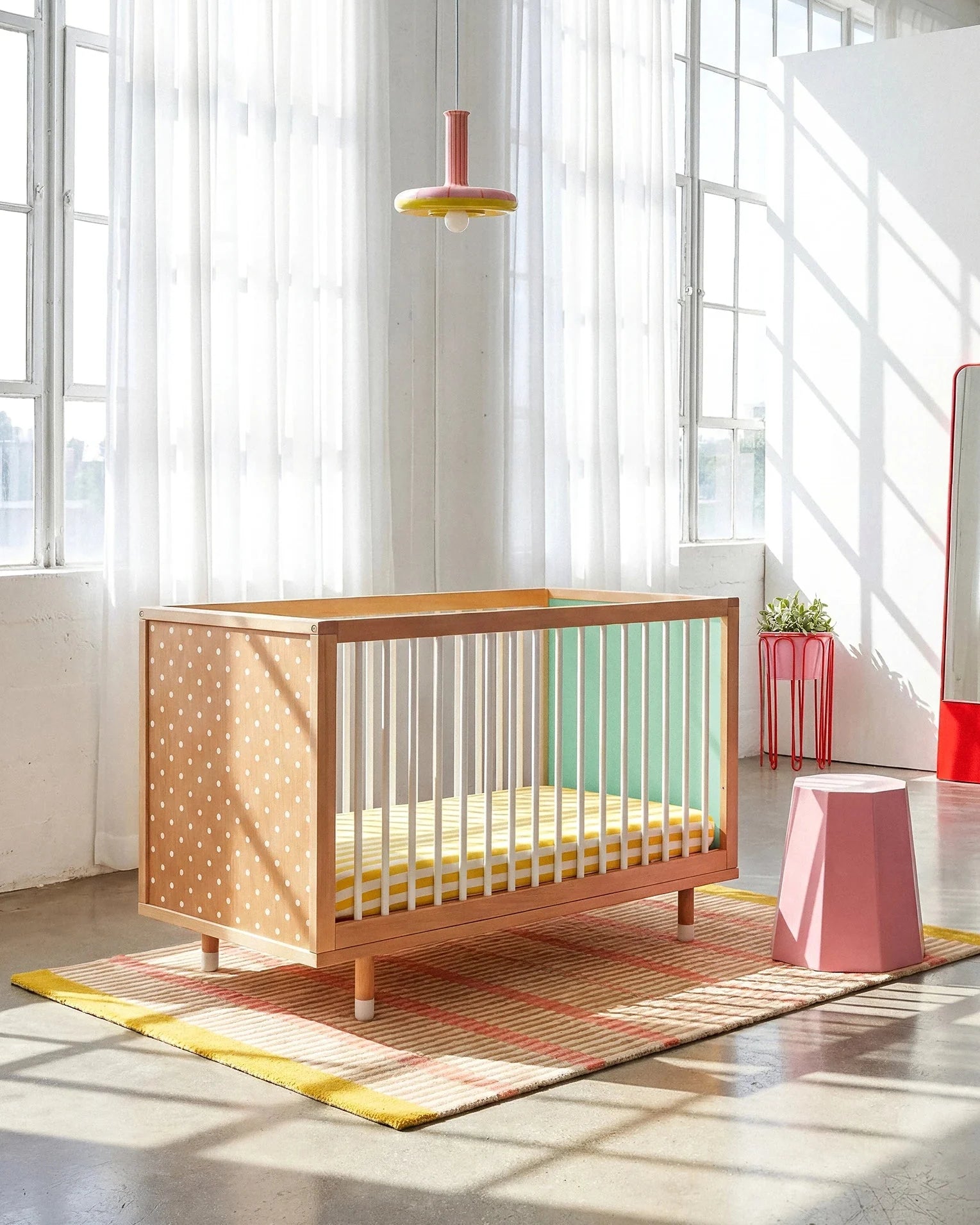 Polkadot and mint panels of the Bold Baby Cot