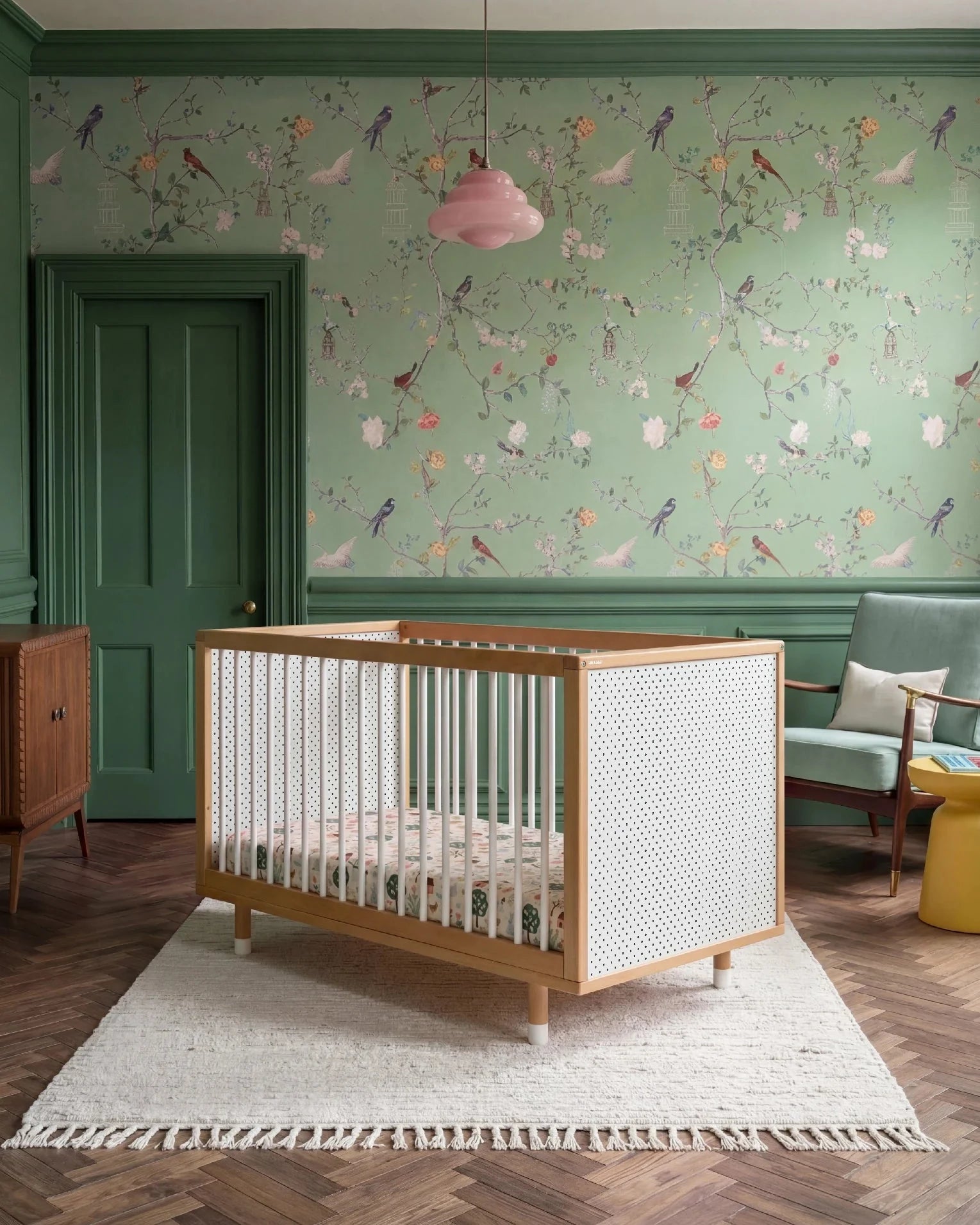 Bold Baby Cot in Pink and Green colourway, front view showing the pegboard panel