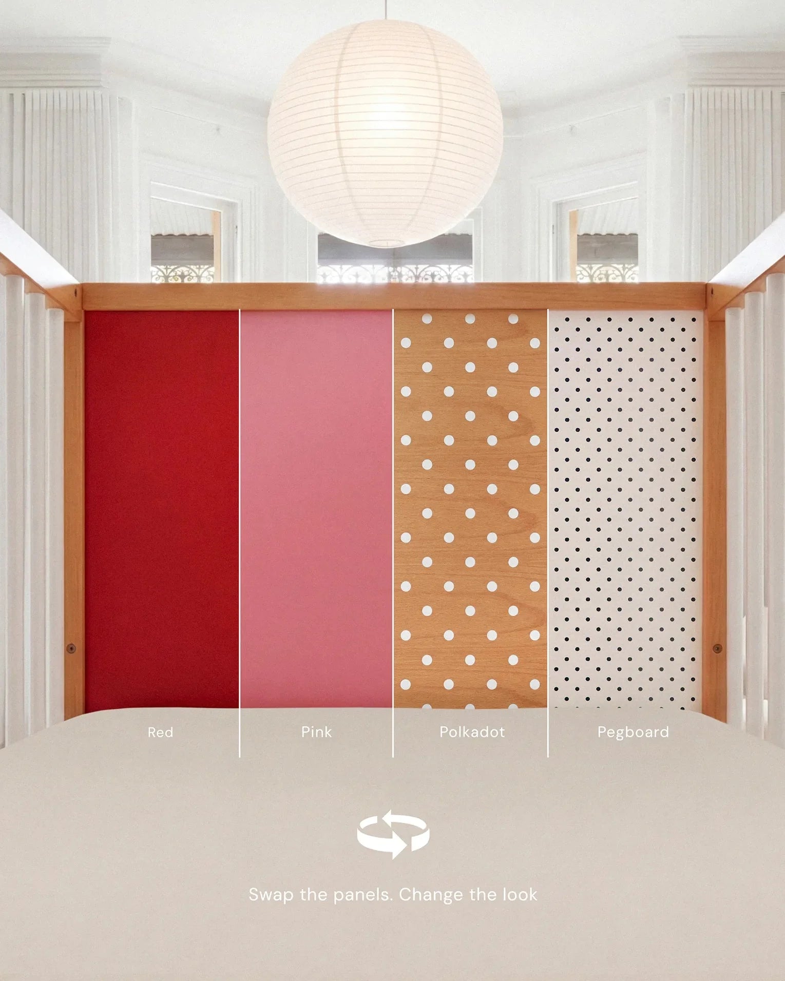 Demonstrating the interchangeable panel swap on the Pink and Red Bold Baby Cot