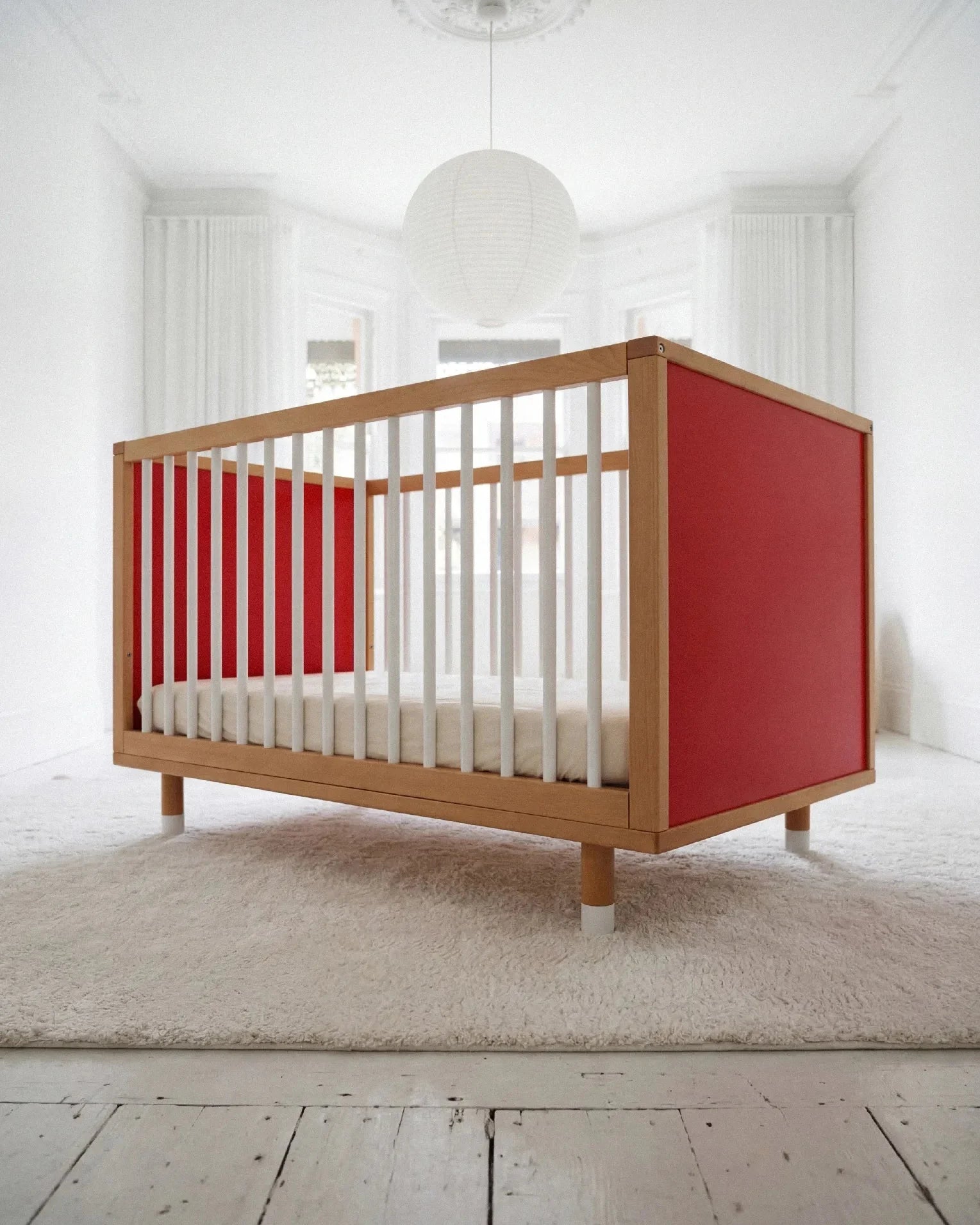 Low-angle front view of the Pink and Red Bold Baby Cot
