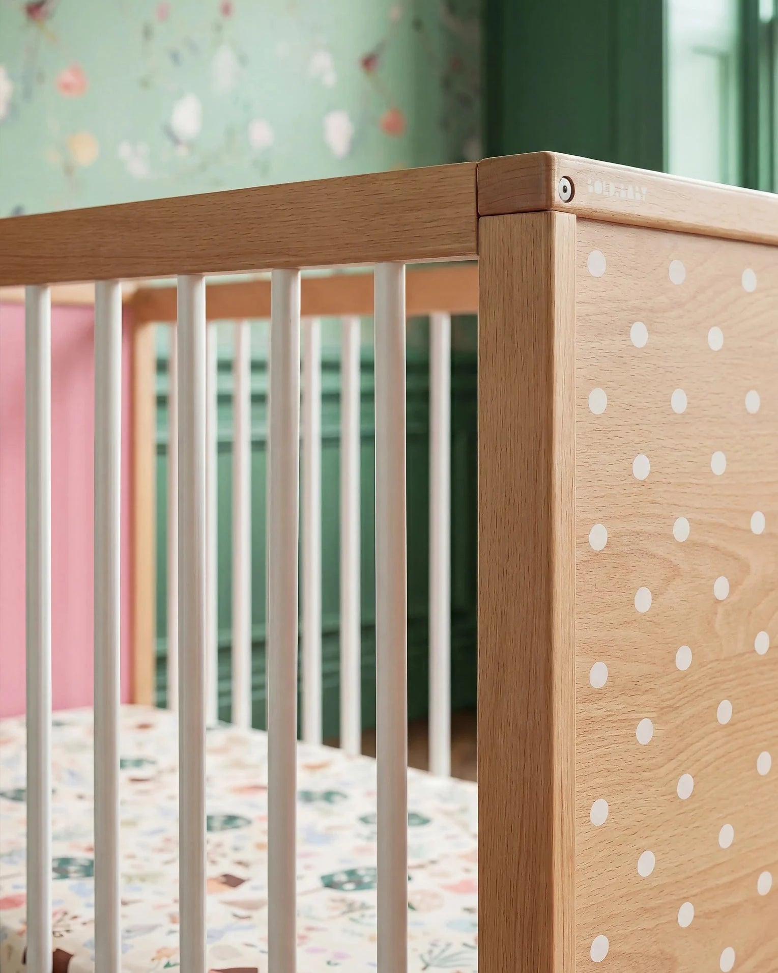Close-up corner detail of the Pink and Green Bold Baby Cot panel