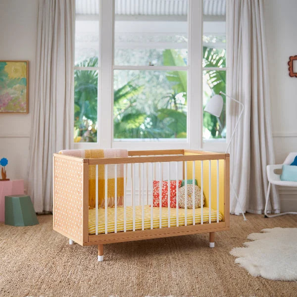 Polkadot and yellow panels of the Bold Baby Cot in a styled nursery