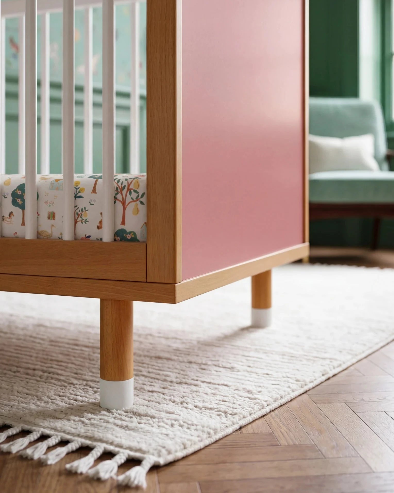 Pink panel and adjustable leg detail of the Pink and Green Bold Baby Cot