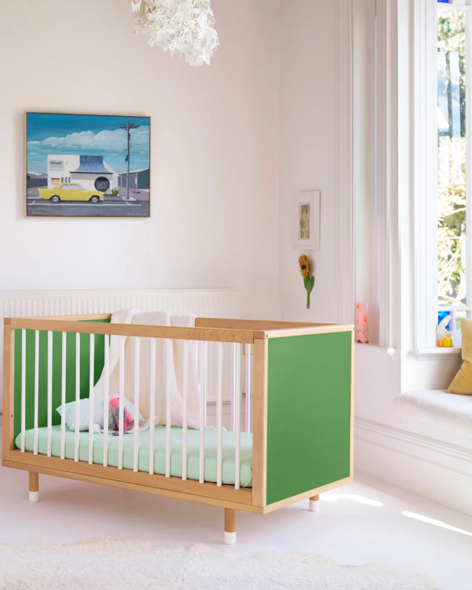 Green and Mint Bold Baby Cot styled in a nursery setting. Green panels on display.