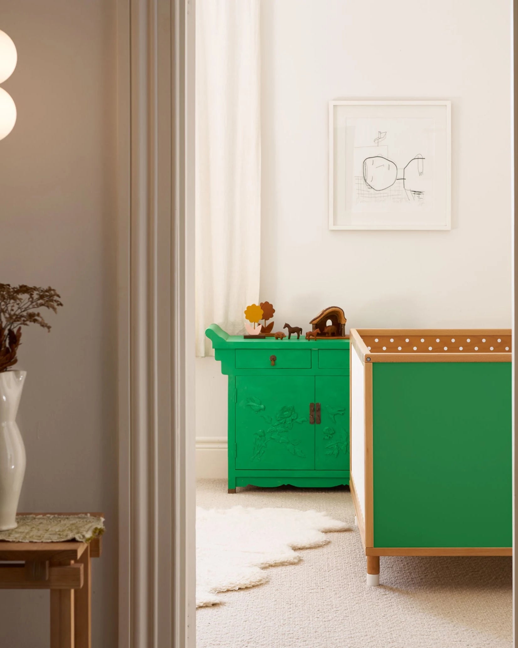Green and Mint Bold Baby Cot in a stylish nursery. Green and polkadot panels on display.