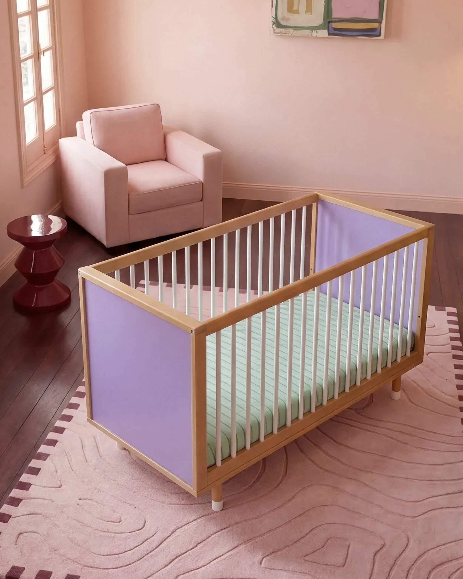 Top-down three-quarter view of the Lilac and Teal Bold Baby Cot