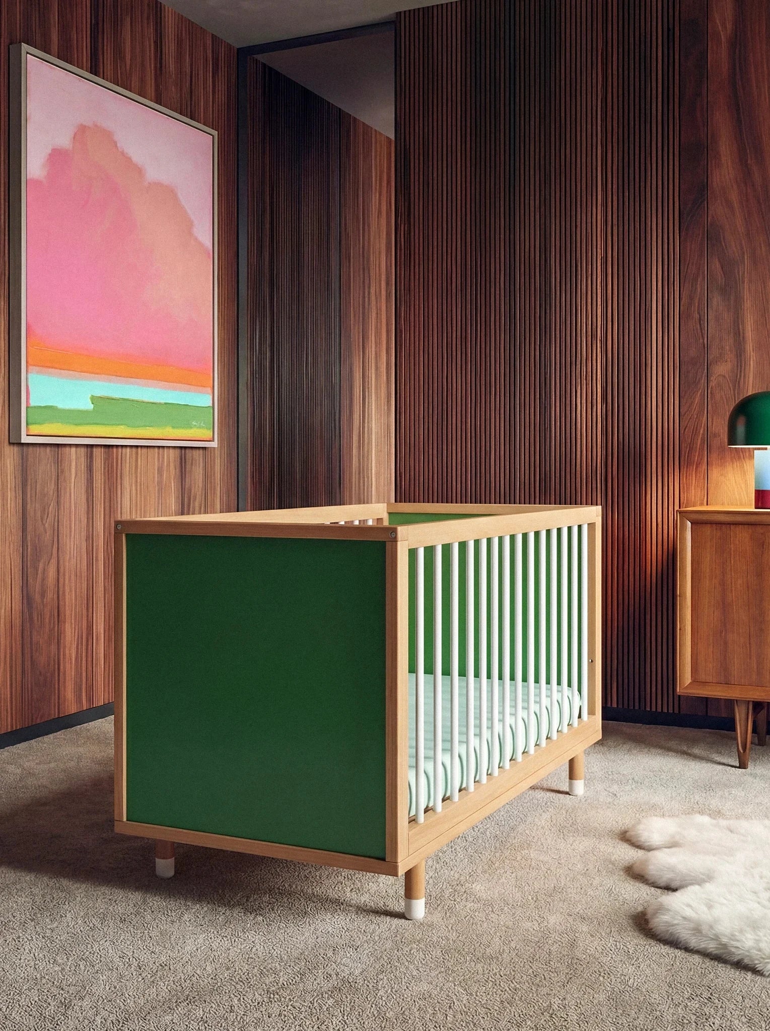 Bold Baby Cot in Green and Mint colourway, front three-quarter view showing the green panel