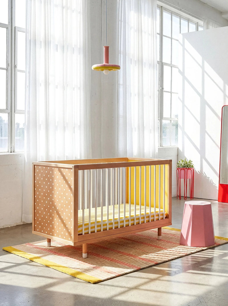 Polkadot and yellow panels of the Bold Baby Cot