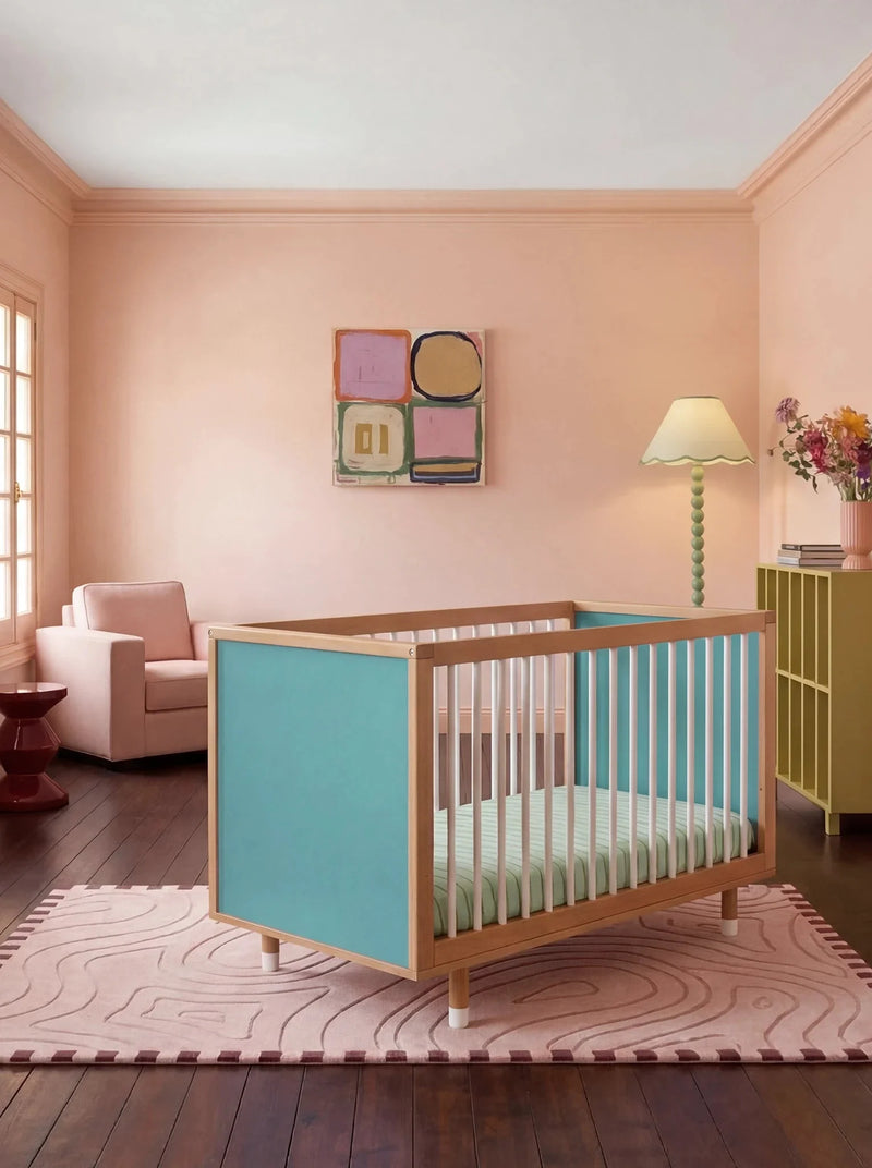 Bold Baby Cot in Lilac and Teal colourway, front three-quarter view showing the teal panel