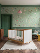 Bold Baby Cot in Pink and Green colourway, front view showing the pegboard panel
