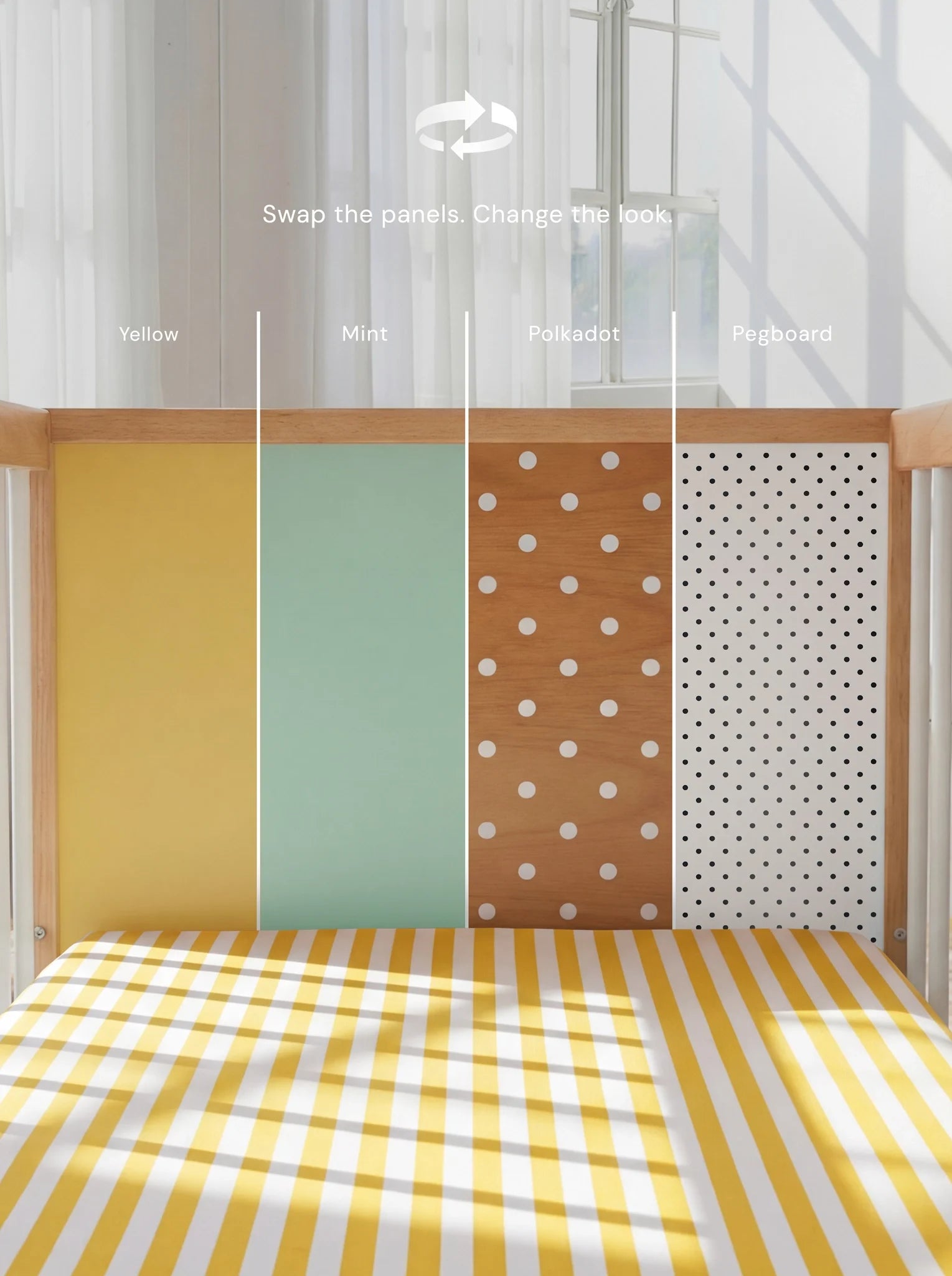 Demonstrating the interchangeable panel swap on the Yellow and Mint Bold Baby Cot