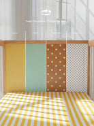 Demonstrating the interchangeable panel swap on the Yellow and Mint Bold Baby Cot