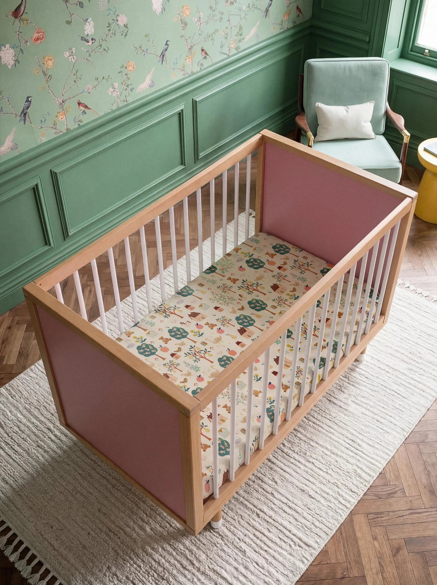 Overhead view of the Pink and Green Bold Baby Cot. Pink panels on display.