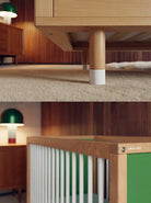 Close-up detail of the Green and Mint Bold Baby Cot adjustable leg and timber frame