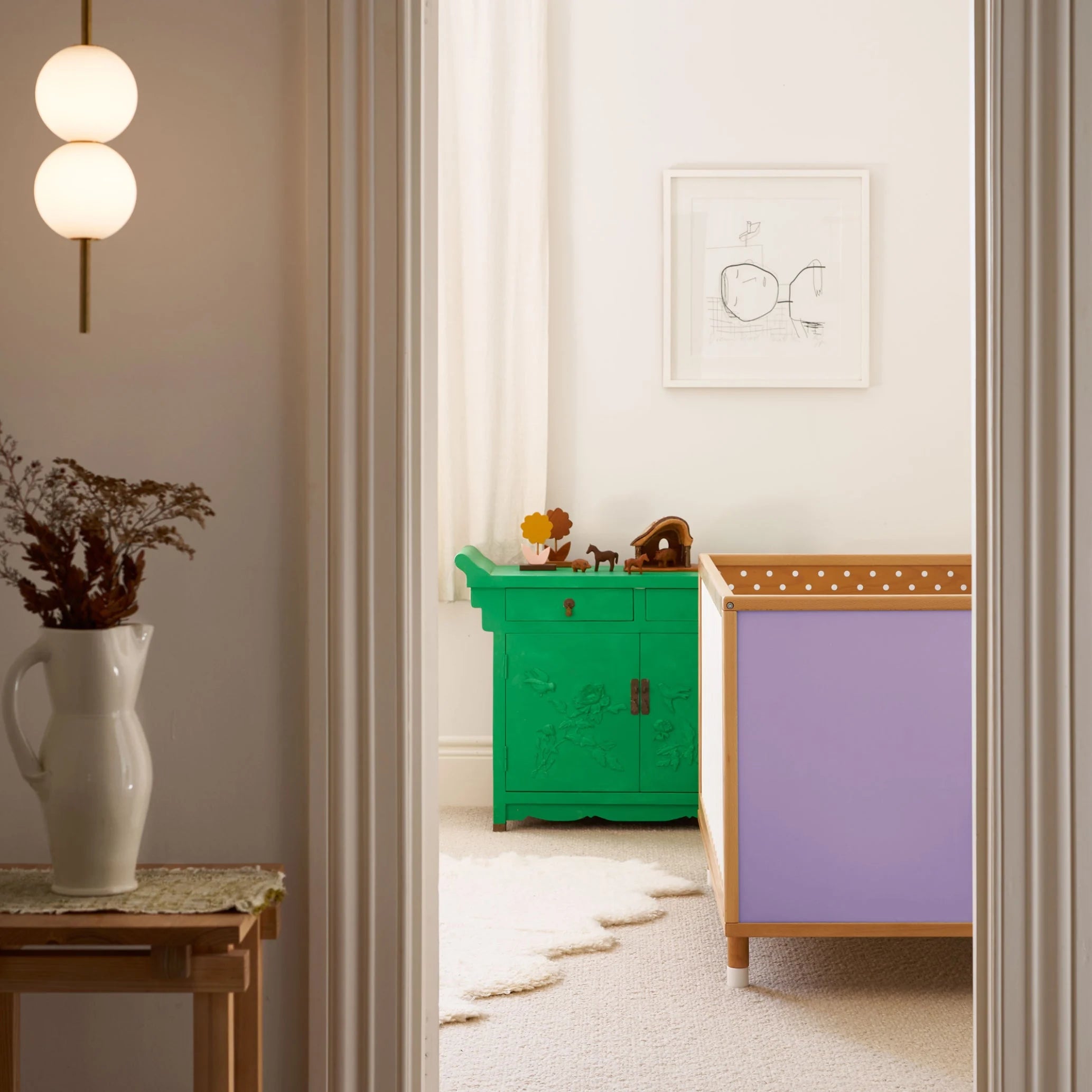 Lilac and polkadot panels of the Bold Baby Cot shown in a styled nursery. 