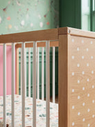 Close-up corner detail of the Pink and Green Bold Baby Cot panel