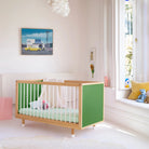 Green and Mint Bold Baby Cot styled in a nursery setting. Green panels on display.
