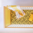 Overhead view of a yellow panel of the Bold Baby Cot