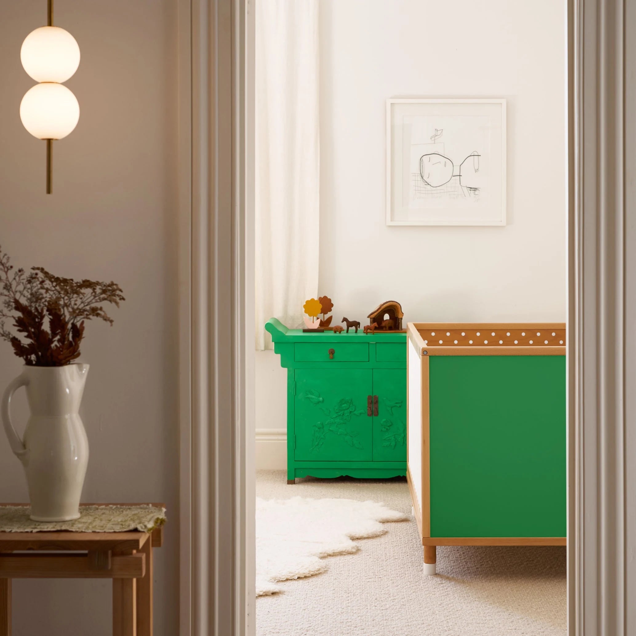 Green and Mint Bold Baby Cot in a stylish nursery. Green and polkadot panels on display.