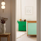 Green and Mint Bold Baby Cot in a stylish nursery. Mint and polkadot panels on display.