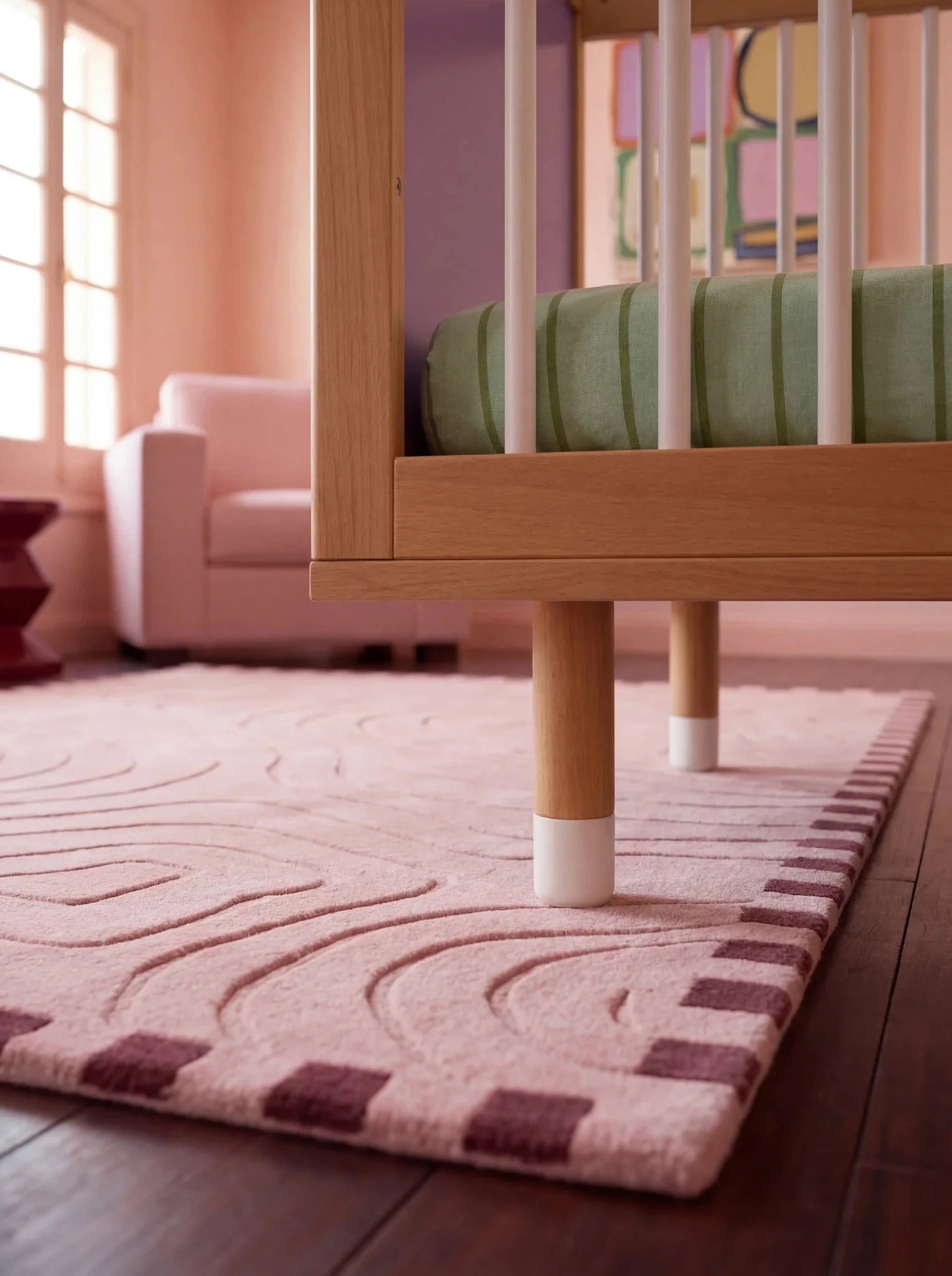 Detail of the adjustable legs on the Lilac and Teal Bold Baby Cot