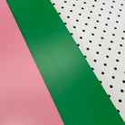 Pink, green and pegboard Bold Baby Cot panels.