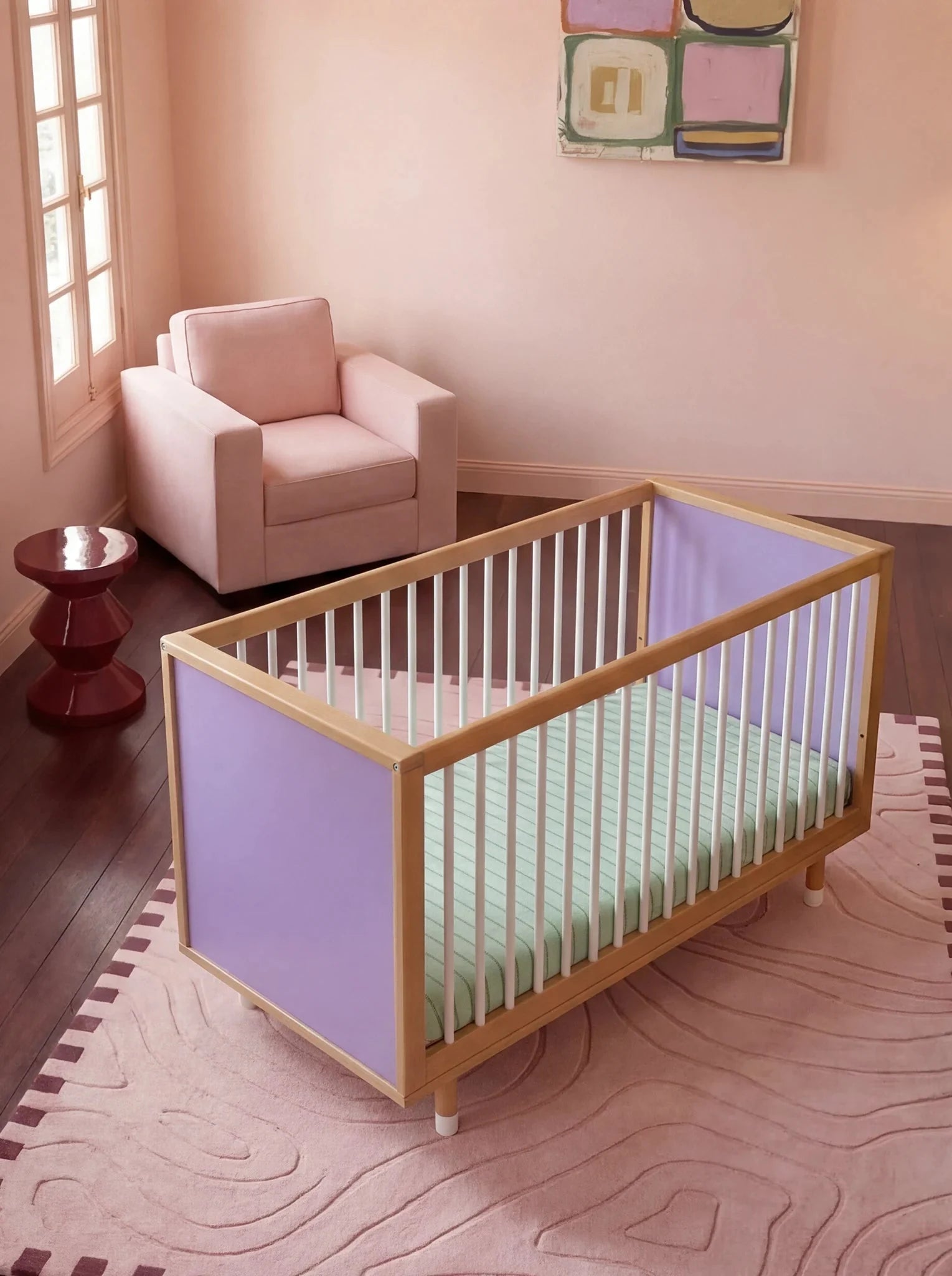 Top-down three-quarter view of the Lilac and Teal Bold Baby Cot