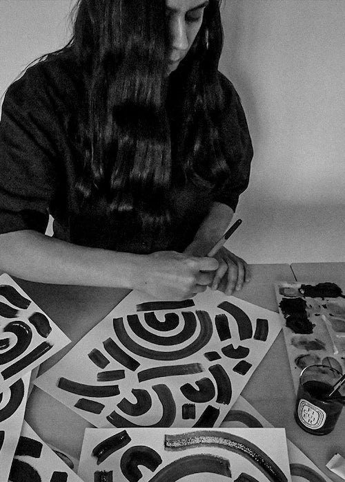 A woman painting in a studio