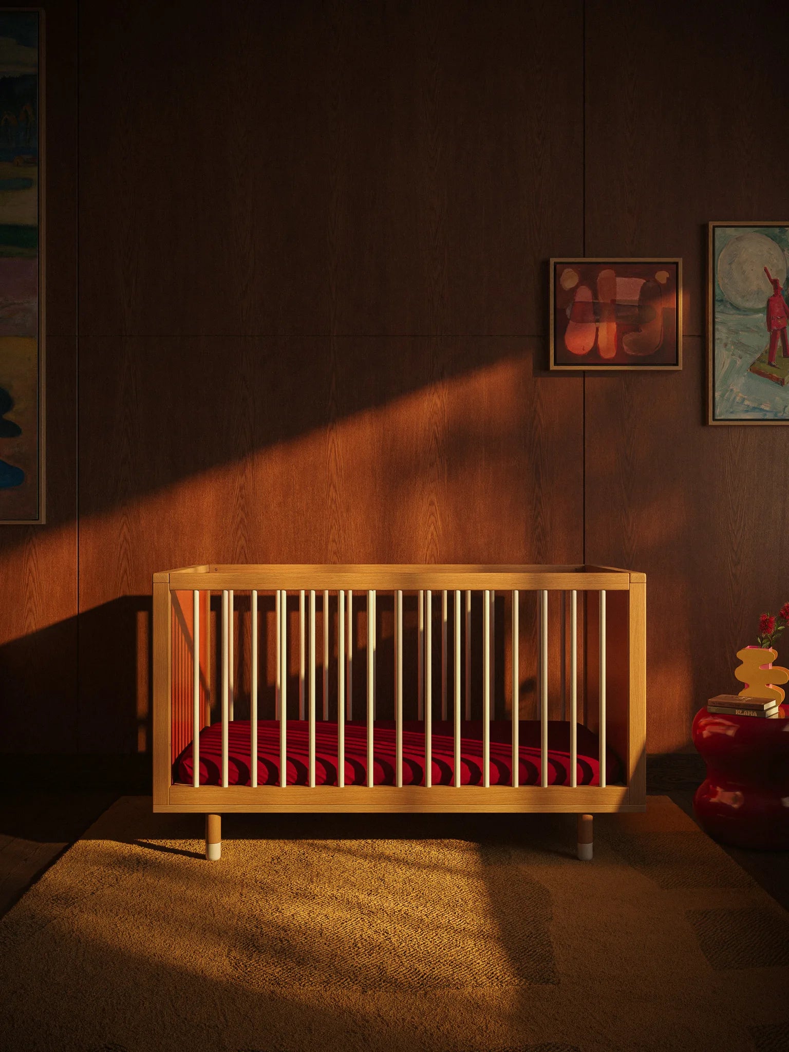 Side view of the Bold Baby Art Series cot by Janelle Burger, with maroon mattress.